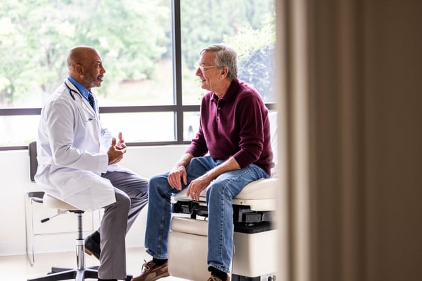 doctor sitting down and talking to patient