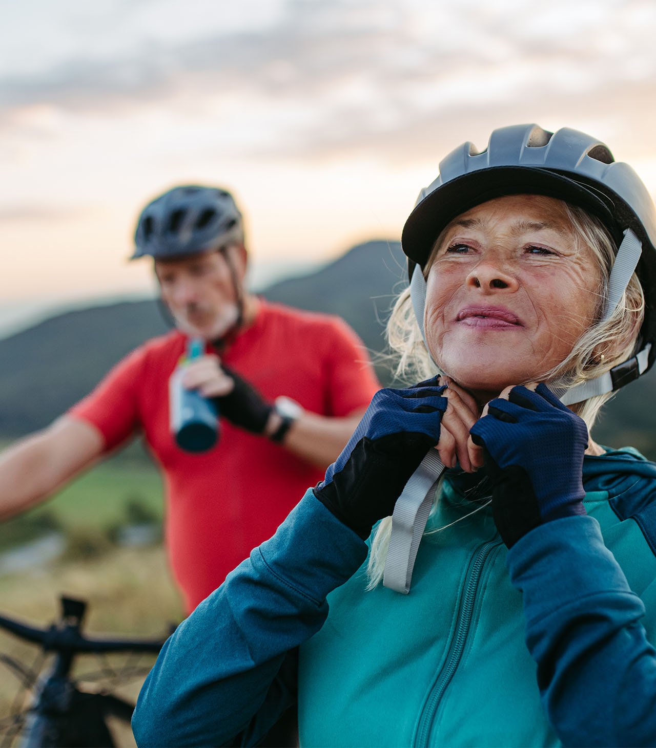 elder women clasping her bicycle helmet 