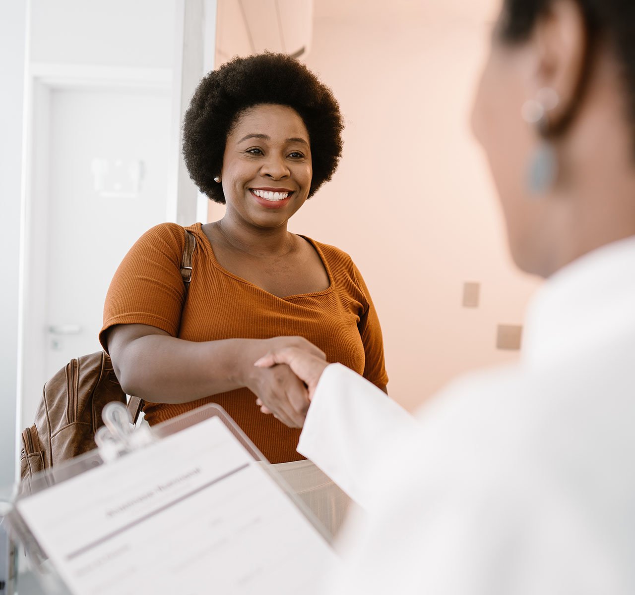 women patient smiling at physician 