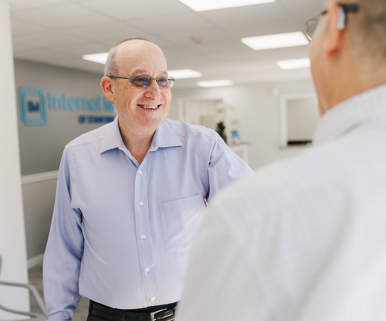 man smiling at physician